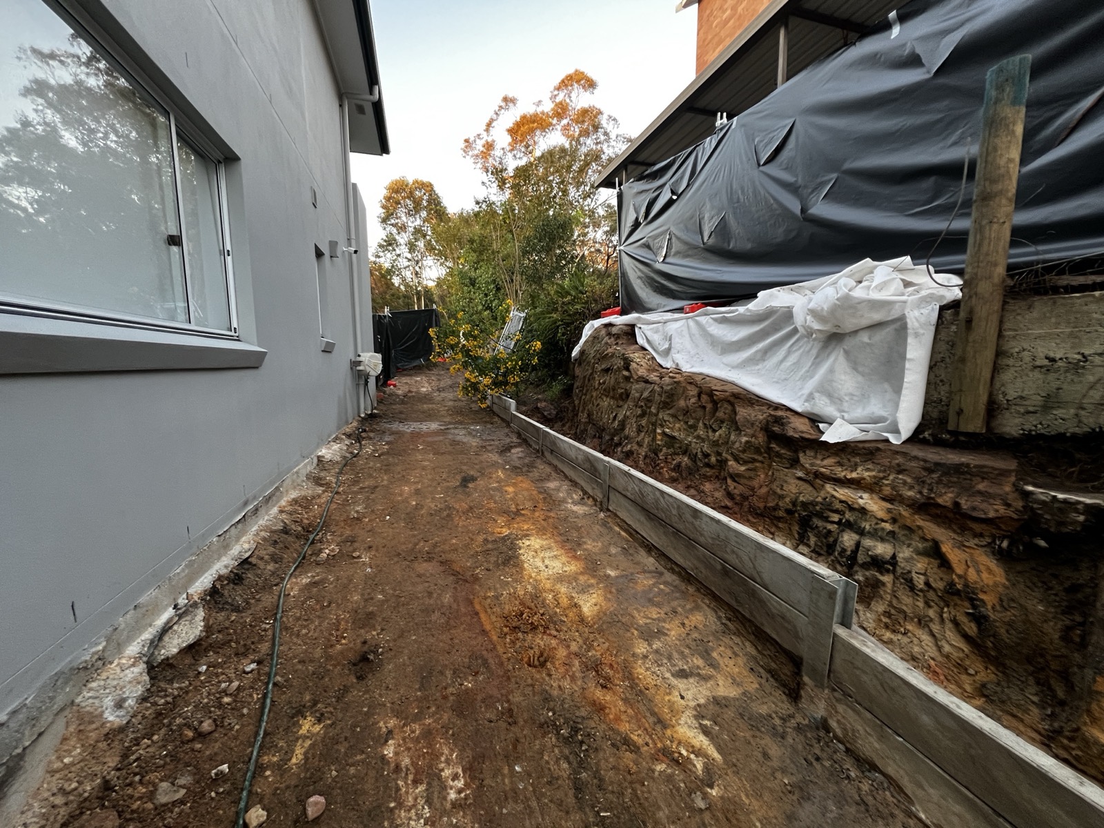 External containment sheeting for friable asbestos works beside a residence